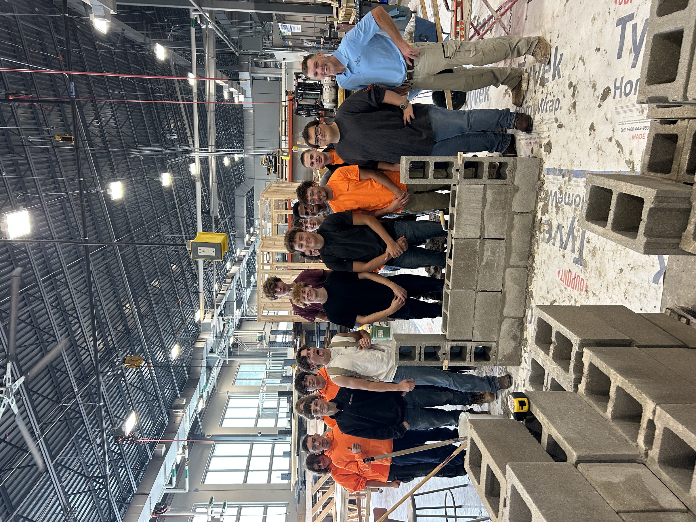 Keith Young and students learning masonry skills